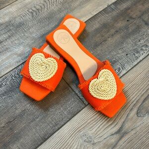 Adorable orange burlap slide with rope heart